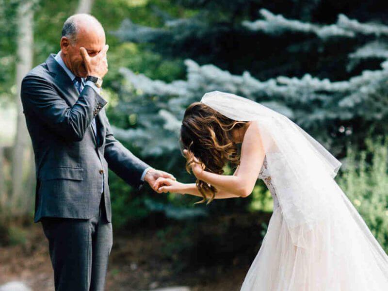 Bride hugging father goodbye at end of wedding