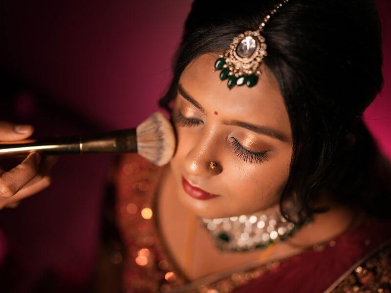 Bridesmaids helping bride get ready candid moment