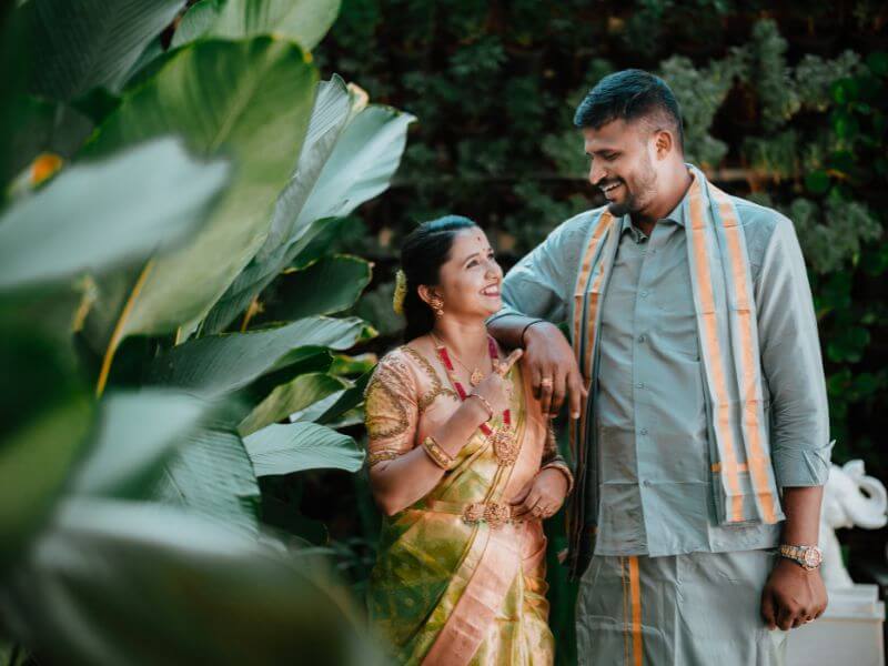 Bride laughing naturally while fixing groom's tie