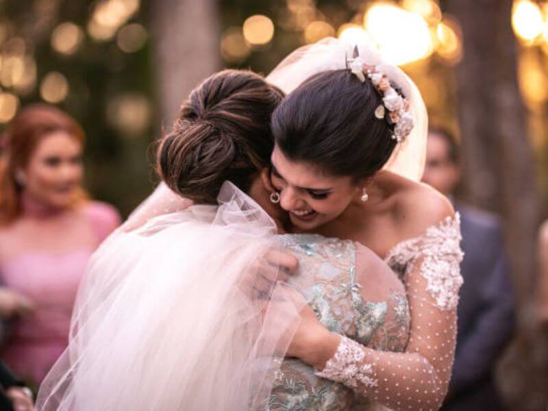 Mother emotional seeing bride in dress